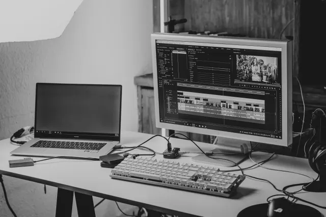 Video editing desk with a monitor showing an editing timeline